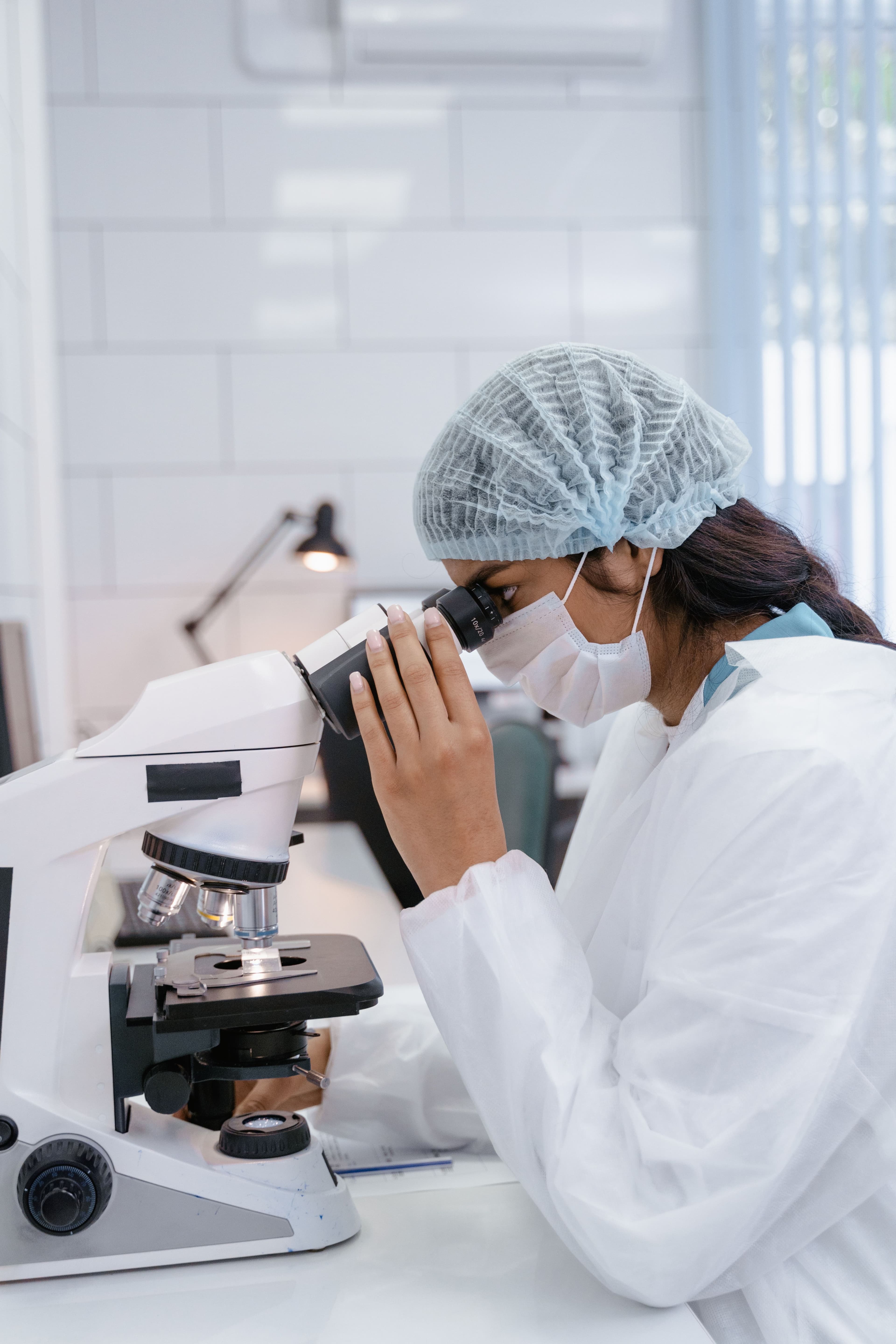 Scientist examining samples under a microscope